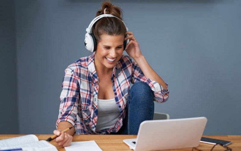Woman learning through online courses on a laptop